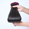 Raw Cambodian Bone Straight Hair Bundles held in hand, showcasing silky and smooth texture.